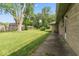 Expansive backyard showcases lush green lawn, mature trees, and well-maintained stone facade of home at 1613 Park Rd, Anderson, IN 46011