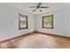 Bright bedroom with hardwood floors and windows offers natural light at 1613 Park Rd, Anderson, IN 46011
