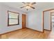 Bedroom with hardwood floors, ceiling fan, closet, and bright natural light at 1613 Park Rd, Anderson, IN 46011