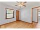 Cozy bedroom with hardwood floors, ceiling fan, and natural light at 1613 Park Rd, Anderson, IN 46011