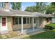 Charming single-story home featuring a covered porch, stone facade, and well-maintained landscaping at 1613 Park Rd, Anderson, IN 46011