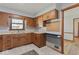 Traditional kitchen featuring wood cabinets, tile flooring, and a view from over the sink at 1613 Park Rd, Anderson, IN 46011