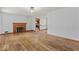 Spacious living room boasts hardwood floors and a classic fireplace, perfect for cozy gatherings at 1613 Park Rd, Anderson, IN 46011