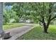 Spacious backyard with grass and a brick patio, surrounded by mature trees at 1618 Villa Ave, Indianapolis, IN 46203