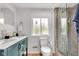 Well-lit bathroom with double vanity, stylish tiling, walk-in shower and modern fixtures at 1618 Villa Ave, Indianapolis, IN 46203