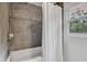 Bathroom features a tile shower and tub, with a window providing natural light at 1618 Villa Ave, Indianapolis, IN 46203