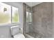 Modern bathroom showcasing a glass-enclosed shower with beautiful stone accents and a window at 1618 Villa Ave, Indianapolis, IN 46203