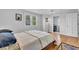 Sun-filled bedroom with wood floors, neutral paint scheme and ensuite bath at 1618 Villa Ave, Indianapolis, IN 46203