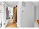 Hallway view featuring hardwood floors, light walls, and closet with a distinctive door design at 1618 Villa Ave, Indianapolis, IN 46203