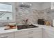 Modern kitchen featuring stone backsplash, new stainless appliances, and white cabinets at 1618 Villa Ave, Indianapolis, IN 46203
