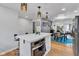This kitchen features white cabinets, stainless steel appliances, and a cozy island with seating at 1618 Villa Ave, Indianapolis, IN 46203