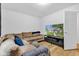 Comfortable living room with sectional sofa, large TV, and wood flooring at 1618 Villa Ave, Indianapolis, IN 46203