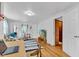 Open-concept living area with hardwood floors, a modern rug, and entertainment center with television at 1618 Villa Ave, Indianapolis, IN 46203