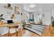 Bright living area featuring a desk area, hardwood floors, a modern rug, and natural light at 1618 Villa Ave, Indianapolis, IN 46203