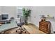 Home office with large window, black office chair, modern desk, and shelving at 1618 Villa Ave, Indianapolis, IN 46203