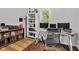 Office area with wood floor, large window for natural light, bookshelves and desk at 1618 Villa Ave, Indianapolis, IN 46203