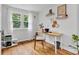 Bright and airy home office featuring a modern desk, natural light, and hardwood floors at 1618 Villa Ave, Indianapolis, IN 46203