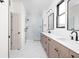 Bathroom featuring a double sink vanity, quartz counters, and marble tiled glass-enclosed shower at 1654 Fernley Dr, Westfield, IN 46074