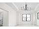 Bright bedroom with a tray ceiling, modern lighting fixture and large black window frames at 1654 Fernley Dr, Westfield, IN 46074