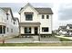 Charming two-story home boasts a modern farmhouse design and welcoming curb appeal with landscaped front yard at 1654 Fernley Dr, Westfield, IN 46074
