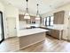 Well-lit kitchen with an island, stainless steel appliances, pendant lighting, and neutral cabinets at 1654 Fernley Dr, Westfield, IN 46074