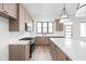 Stylish kitchen boasts stainless appliances, island, granite countertops, and modern lighting fixtures at 1654 Fernley Dr, Westfield, IN 46074
