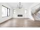 Bright living room features sleek fireplace, hardwood floors, and staircase at 1654 Fernley Dr, Westfield, IN 46074