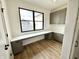 Office space with wood floors, a corner desk, storage cabinets, and a large window at 1654 Fernley Dr, Westfield, IN 46074