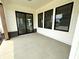 Covered patio with large sliding glass doors and modern black trim windows at 1654 Fernley Dr, Westfield, IN 46074