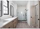 Bathroom features a double sink vanity, black hardware, white countertop and tiled walk-in shower at 1655 Carrollton Rail Dr, Westfield, IN 46074