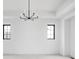 Minimalist bedroom features recessed lights, neutral carpet, black trimmed windows, and modern light fixture at 1655 Carrollton Rail Dr, Westfield, IN 46074