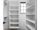 Modern closet features built-in shelves, white walls, recessed lighting, and a black trimmed window at 1655 Carrollton Rail Dr, Westfield, IN 46074
