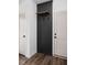 A stylish entryway features a black accent wall with hooks and a wooden shelf at 1655 Carrollton Rail Dr, Westfield, IN 46074