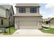 Charming two-story home with a neutral exterior, garage, and well-maintained lawn at 1655 Carrollton Rail Dr, Westfield, IN 46074