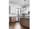 Bright, modern kitchen featuring white upper cabinets, stainless steel appliances, and a hardwood floor at 1655 Carrollton Rail Dr, Westfield, IN 46074