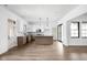 Bright open floor plan with modern kitchen, stainless appliances, white cabinets, and hardwood floors at 1655 Carrollton Rail Dr, Westfield, IN 46074