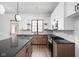 Modern kitchen with white upper cabinets, gray countertops, island, and stainless-steel appliances at 1655 Carrollton Rail Dr, Westfield, IN 46074