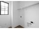 Clean, white laundry room with vinyl plank floors and a single window at 1655 Carrollton Rail Dr, Westfield, IN 46074