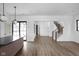 Open living space featuring hardwood flooring, neutral walls, access to backyard, and stairwell at 1655 Carrollton Rail Dr, Westfield, IN 46074