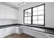 Bright office space with white cabinetry, long gray countertops and a large black-framed window at 1655 Carrollton Rail Dr, Westfield, IN 46074