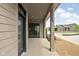 Covered patio featuring a modern sliding glass door and view of the landscaped yard at 1655 Carrollton Rail Dr, Westfield, IN 46074