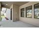 Cozy outdoor patio showcasing beige siding and black-framed windows for a modern touch at 1655 Carrollton Rail Dr, Westfield, IN 46074