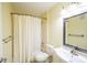 Well-lit bathroom with a shower and tub combination, white fixtures, and a large mirror at 207 Keats Ct # 102, Carmel, IN 46032