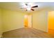 Bedroom featuring neutral carpeting, a ceiling fan, and two entryways at 207 Keats Ct # 102, Carmel, IN 46032