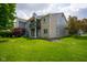 Well-maintained exterior showing a multi-story building, lawn, and garden at 207 Keats Ct # 102, Carmel, IN 46032