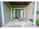 Covered patio featuring a small bench and double doors at 207 Keats Ct # 102, Carmel, IN 46032