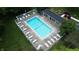 An aerial view of a sparkling community pool with lounge chairs and shade at 207 Keats Ct # 102, Carmel, IN 46032
