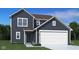 Charming two-story home with dark siding, white trim, and an attached two-car garage at 2086 Rosemont Dr, Columbus, IN 47201