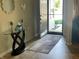 Inviting entryway featuring a glass-top table with decorative accents and an open door to the outside at 2253 Jaybird Dr, Greenfield, IN 46140