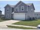 Exterior view of a two-story house features a driveway, garage, and well-maintained lawn at 2253 Jaybird Dr, Greenfield, IN 46140